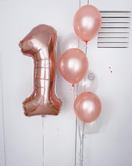 IWERP rose-gold number balloon shines as a stunning birthday centerpiece.