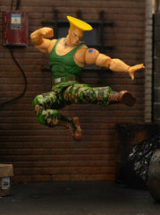 Jada Guile action figure in battle-ready pose on shelf.