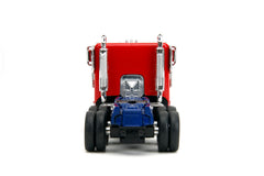 Jada Optimus Prime die-cast robot on chassis for dynamic display.