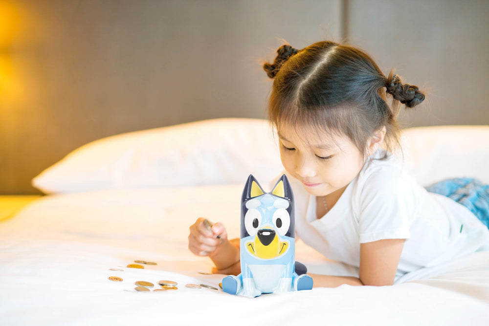 Jay Franco Bluey ceramic piggy bank on shelf adds playful decor.