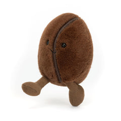 Jellycat Amuseables Coffee Bean sits upright on a counter, a charming decor accent.
