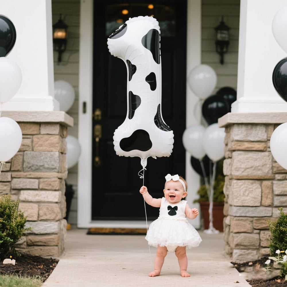 Kelfuoya cow-print number 1 balloon creates a striking backdrop for events.