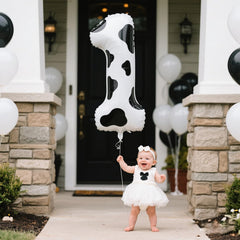 Kelfuoya cow-print number 1 balloon creates a striking backdrop for events.