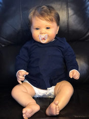 KOKOMANDY 24-inch reborn doll face close-up showing warm, lifelike features for cuddling