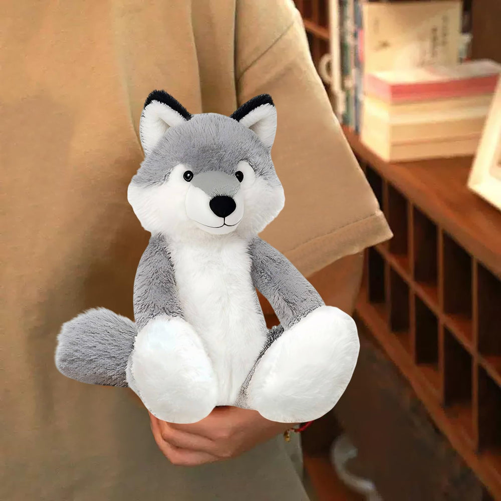 KUUDESOXX Wolf Stuffed Animal resting on a bed adds cozy room decor.