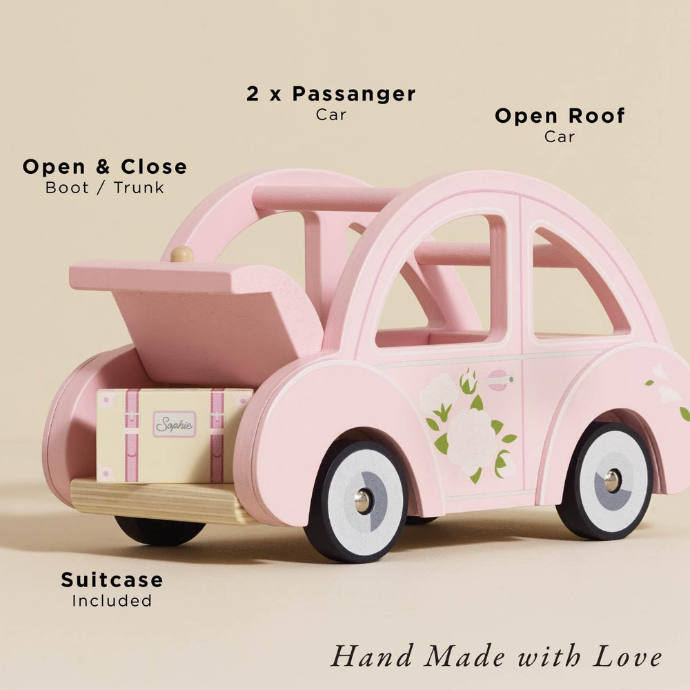 Sophie's pink car with luggage fosters storytelling and role-play in play sets.