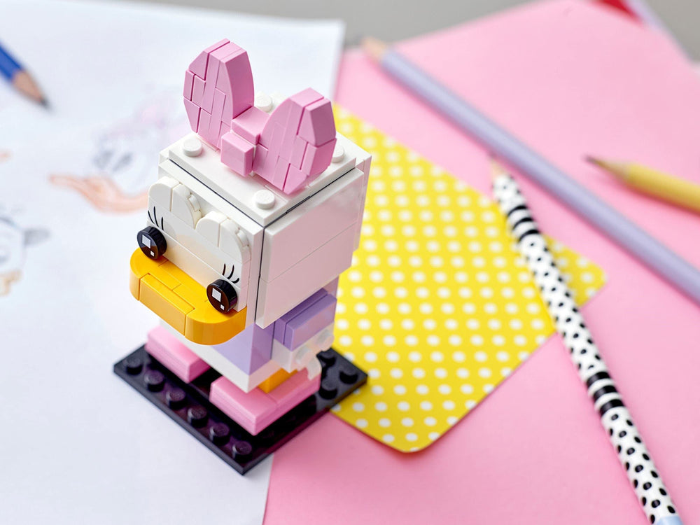 Daisy Duck BrickHeadz on display, ready to brighten a desk or shelf.