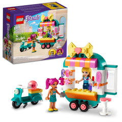 LEGO Friends mobile boutique and scooter tow for on-the-go fashion play.