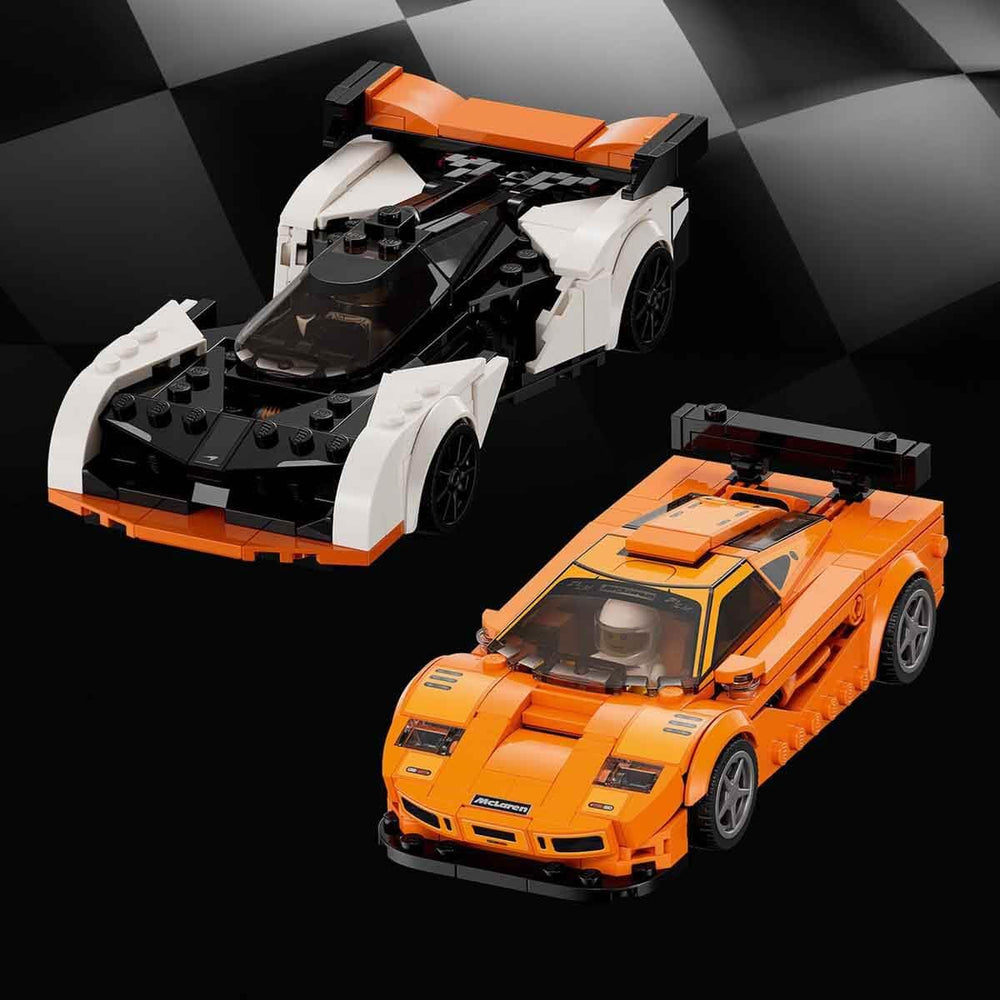 Two LEGO minifigures ready to pilot the McLaren cars