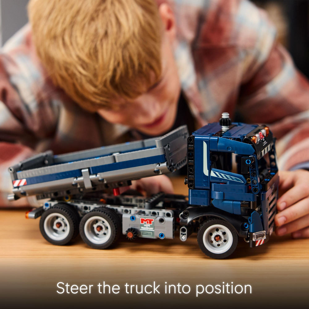 LEGO Technic tipping dump truck build in progress with pieces laid out
