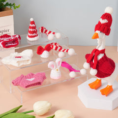 Linastu desk goose on a tidy desk setup in festive outfits.