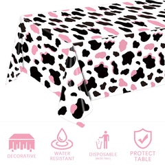 LINHAXM pink cow print tablecloth used as a photo backdrop at a cowgirl party