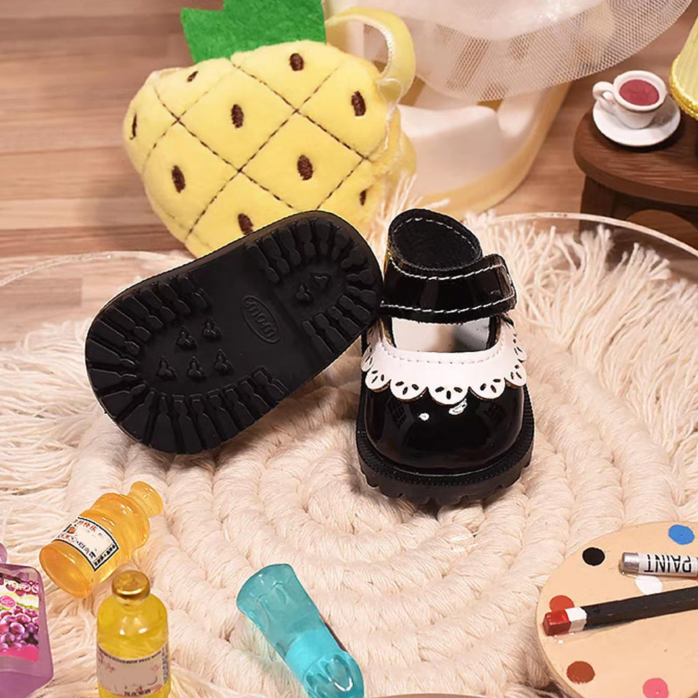Lukax black mini shoes close-up, detailed stitching and realistic miniature design.