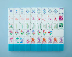 Mahjong Co Celestial tiles with teal-backed design for elegant gameplay.