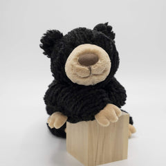 Mary Meyer Cozy Toes Black Bear held under the arm for on-the-go cuddles.