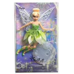 Mattel Tinker Bell doll with white ribbon hair and shimmering wand for magical posing.