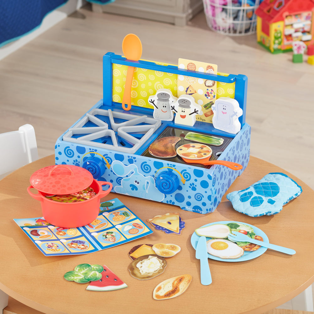 Utensils and paw-shaped oven mitt included in the set for pretend serving