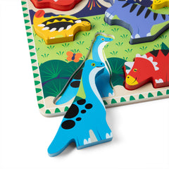 Full-color under-pictures visible beneath Melissa & Doug dinosaur puzzle pieces