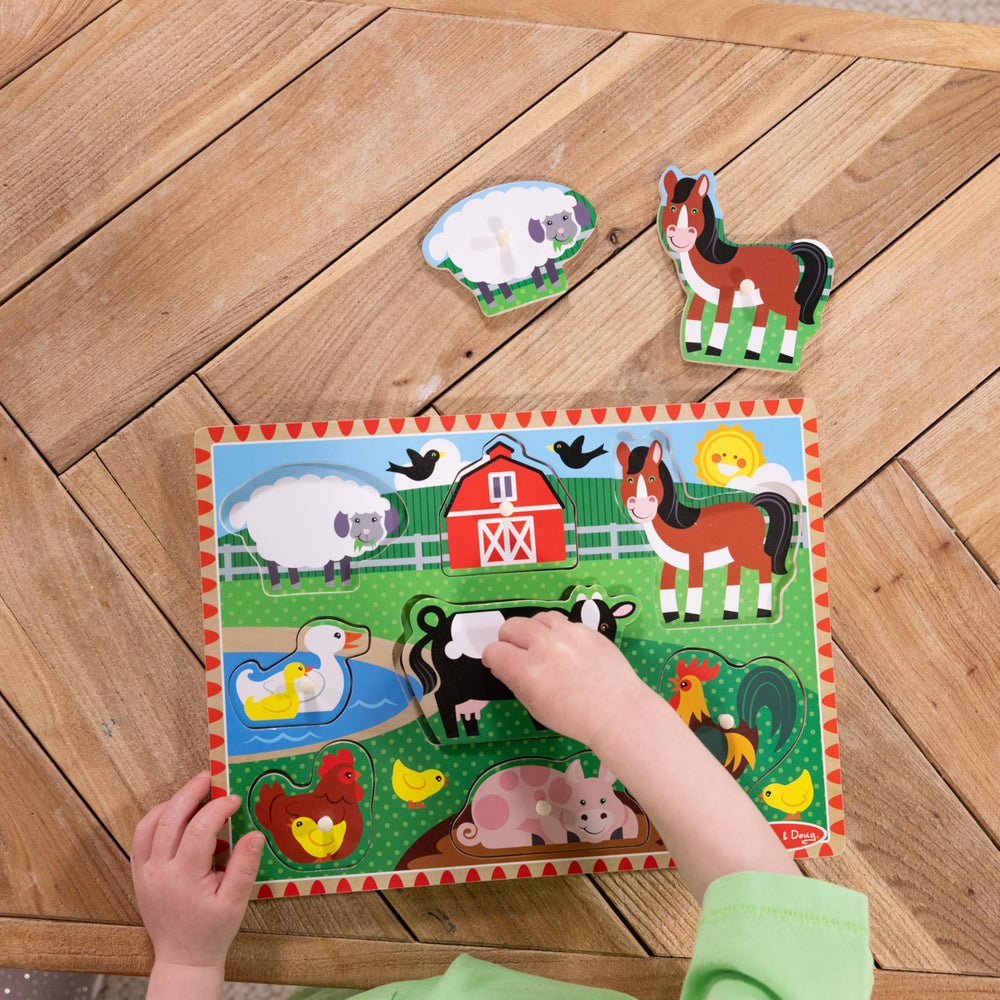 Melissa & Doug easy-grasp pegs support hand strength during puzzle play.