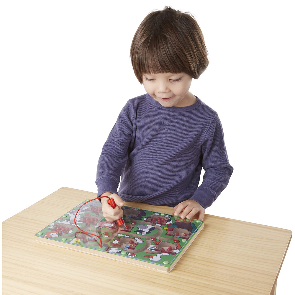 Melissa and Doug Magnetic Wand Number Maze wand attached to sturdy board during play.