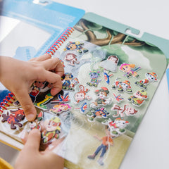 PAW Patrol stickers layered on Jake’s Mountain scene for adventurous storytelling by Melissa & Doug.