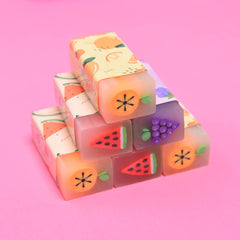 MGTECH fruit erasers trio on desk inspire imaginative writing.