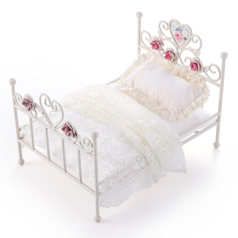 Removable bedding for Minamzee dollhouse bed enables quick scene changes.
