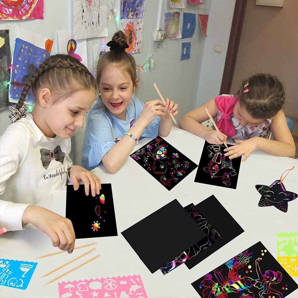 Mocoosy rainbow colors emerging from black coating on paper