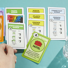 Monopoly Deal card game money cards kept in play to pay debts.