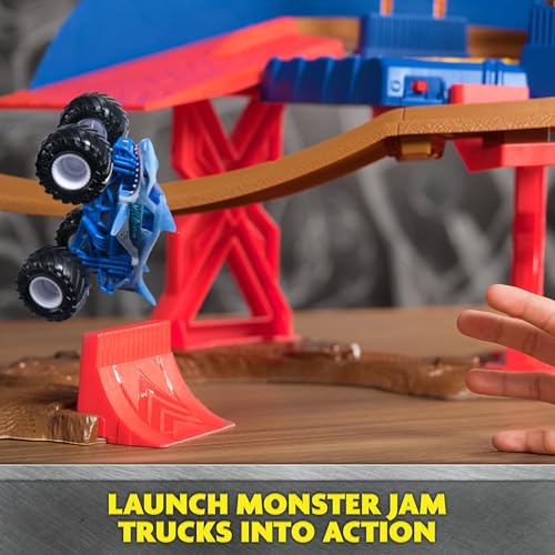 Illuminated Monster Jam race track enhances dramatic night-time play.