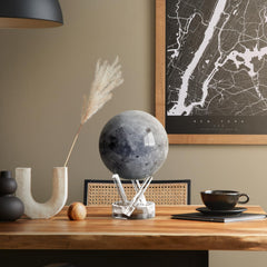 MOVA Moon Globe rotates under ambient light with magnetic-field assist.