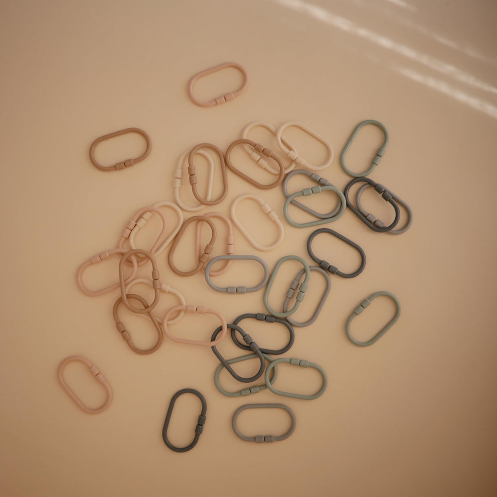 Mushie Chain Link Rings in stone color for reaching and sorting activities