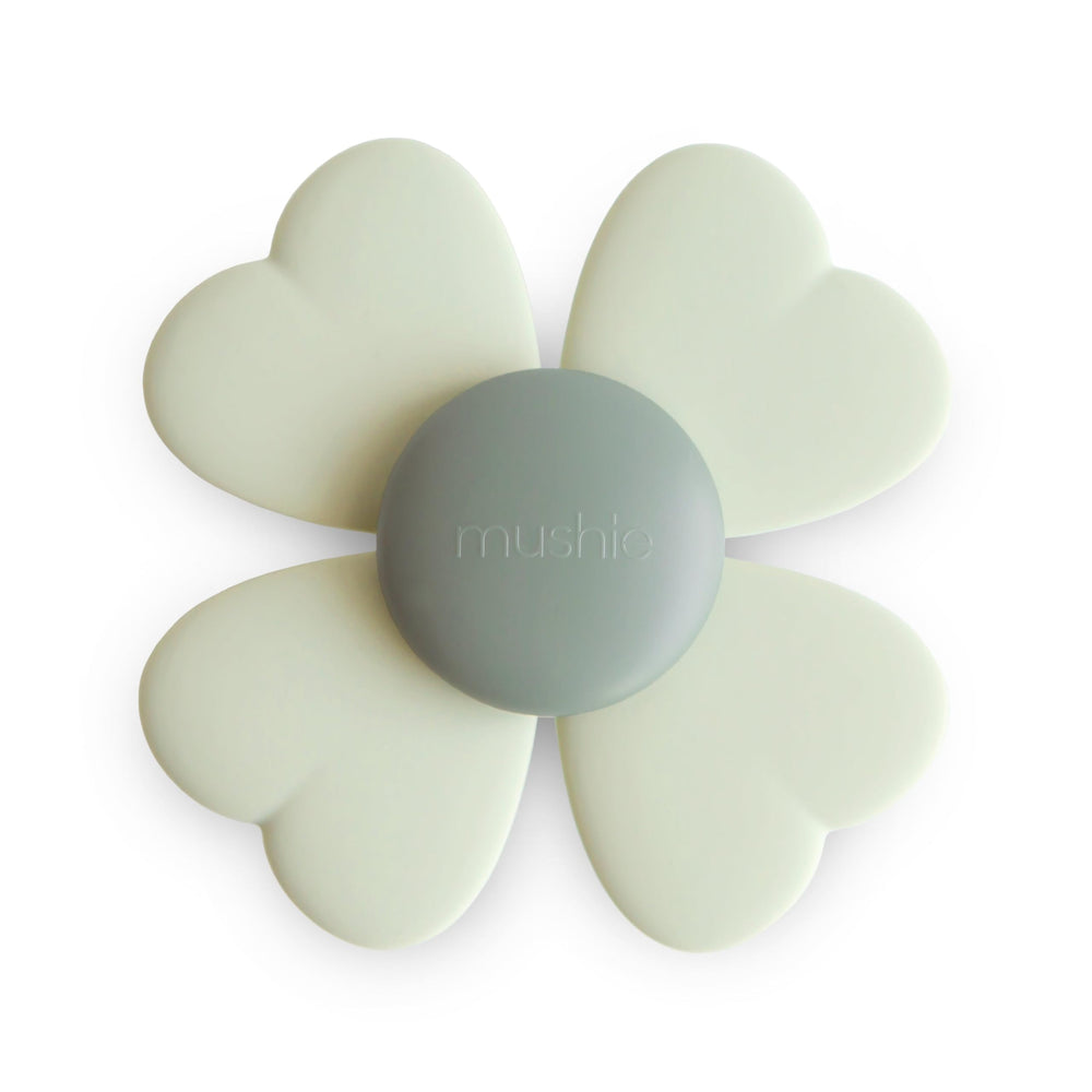Mushie Lucky Suction Spinner Toy attached to tub for soothing bath-time sensory play.