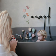 Mushie compact bath toy fits little hands