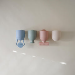 Mushie bath toy with suction cups secured to tub wall for creative waterfall setups