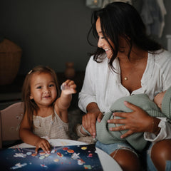 Mushie Space sticker book with handles makes on-the-go play easy.