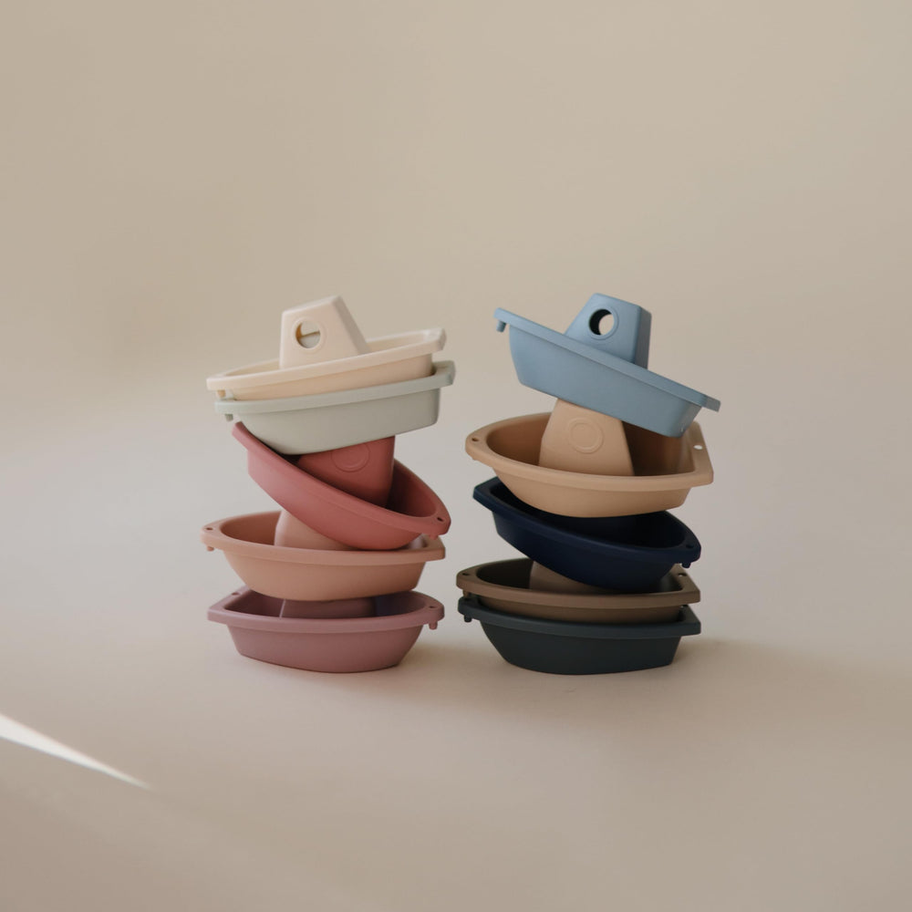 Mushie Stackable Bath Boats Ocean-2, forming a floating train across the tub
