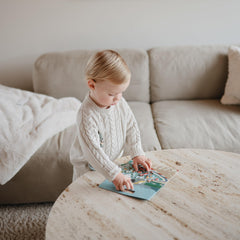 Carrying handles on Mushie sticker book for easy on-the-go play