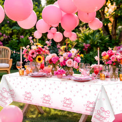 NatNarr Coquette pink bow tablecloth being wiped clean with a damp cloth.