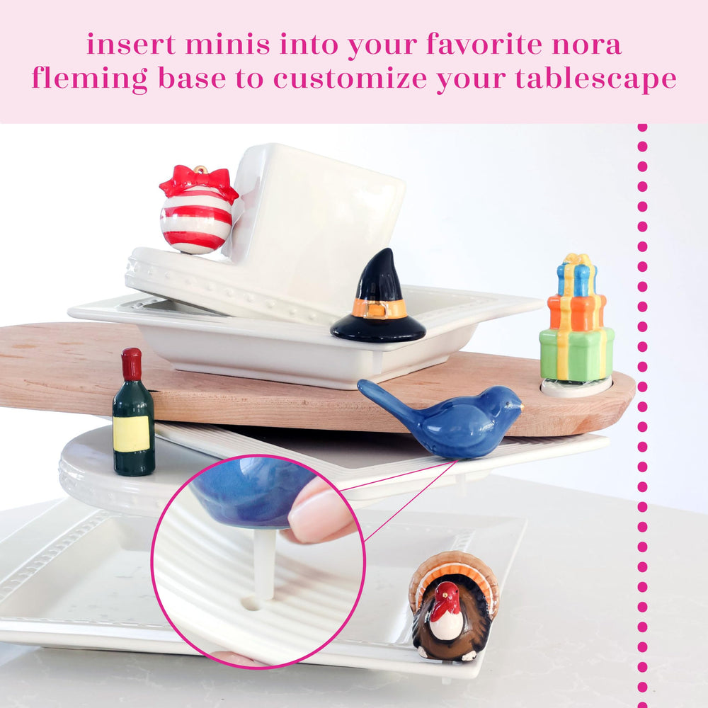 Nora Fleming Lemon Squeeze mini enhances festive centerpieces and place settings.