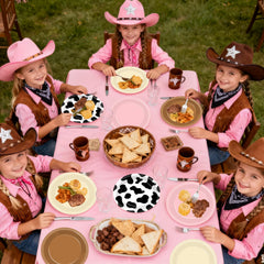 Oitnlaughter Western tableware with cow print creates cohesive rodeo themed party styling