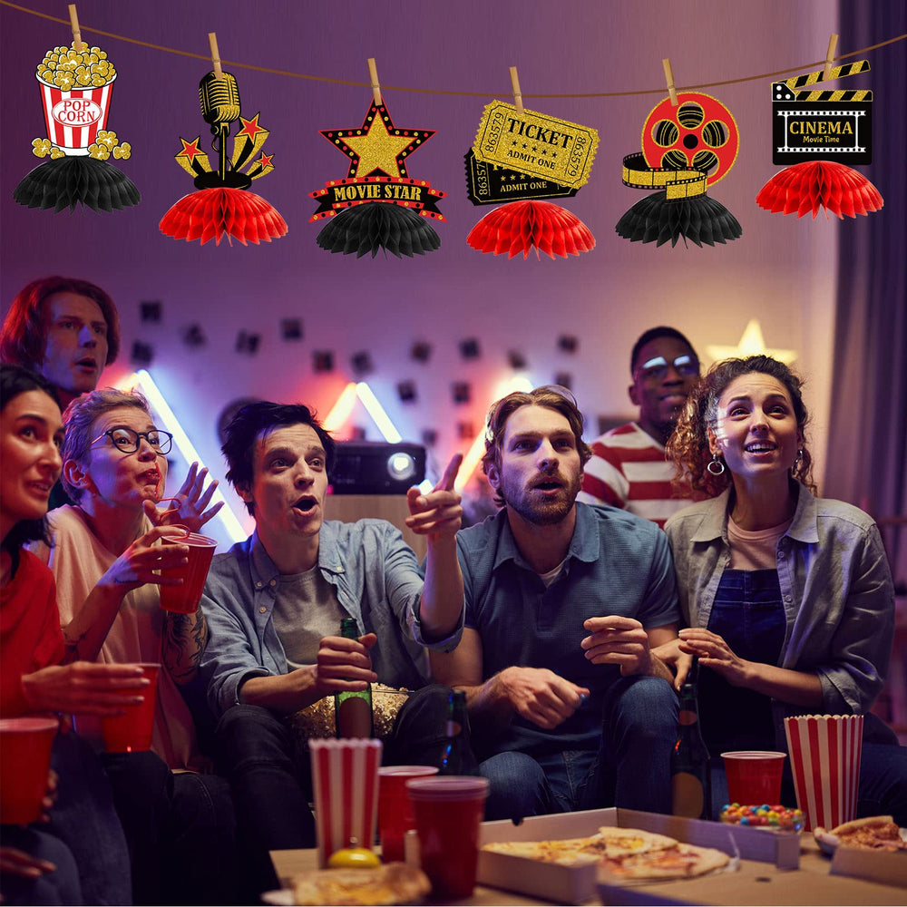 Pajean honeycomb centerpiece with projectors enhances cinema-inspired table display.
