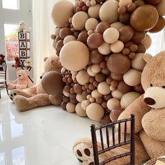 PartyWoo baby shower centerpiece using brown balloons for warm, elegant touches.