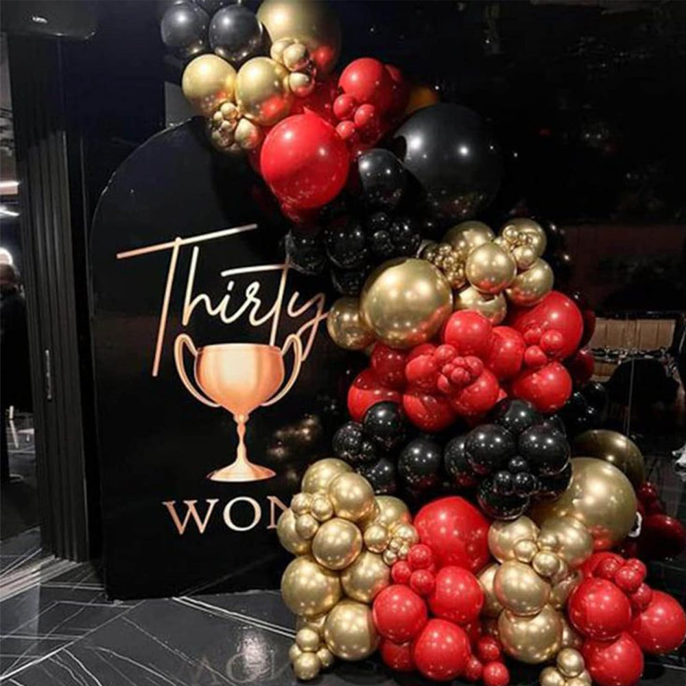 PartyWoo 10-inch red-black-gold balloons add color to arches and photos