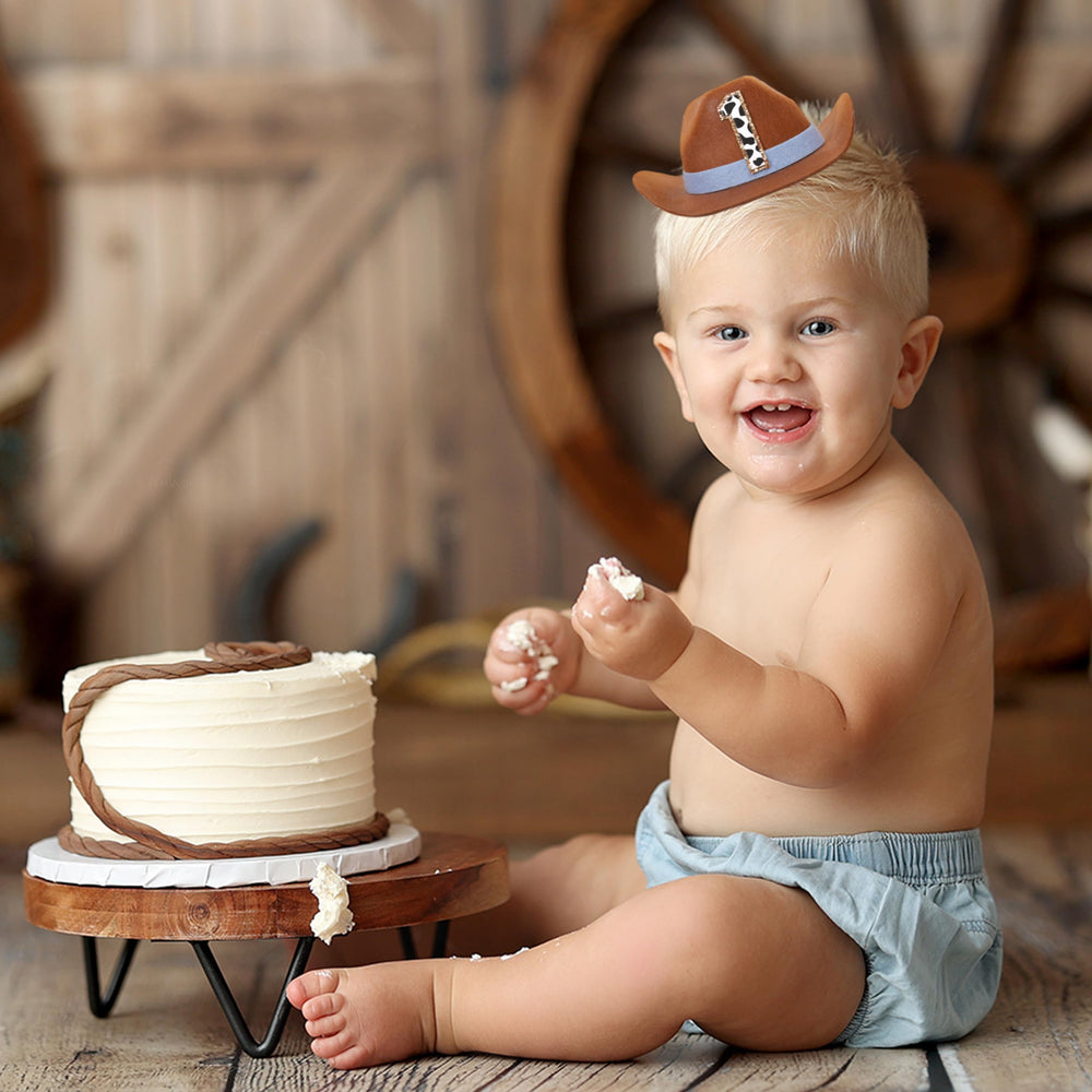 PATRDIO Cowboy 1st Birthday Hat blue worn by baby, elastic band keeps it comfy.