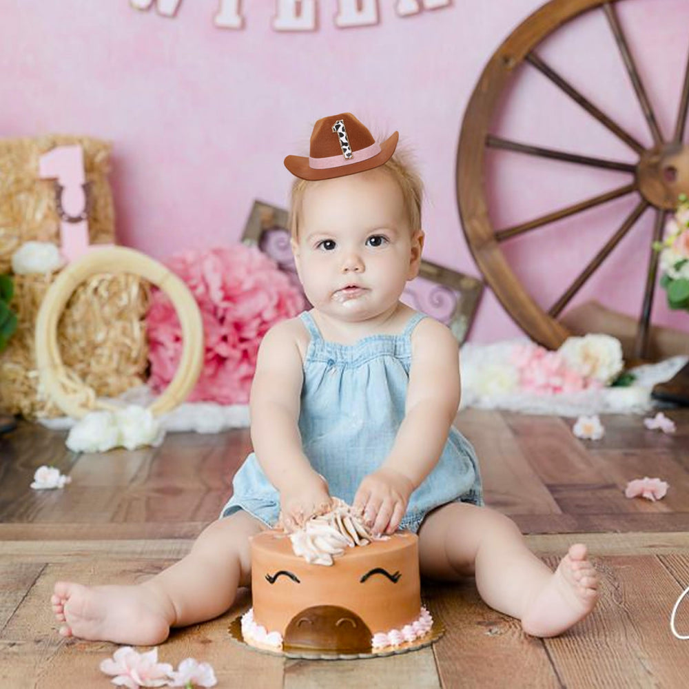 PATRDIO cowboy birthday hat pink on baby head demonstrates easy secure fit with elastic band