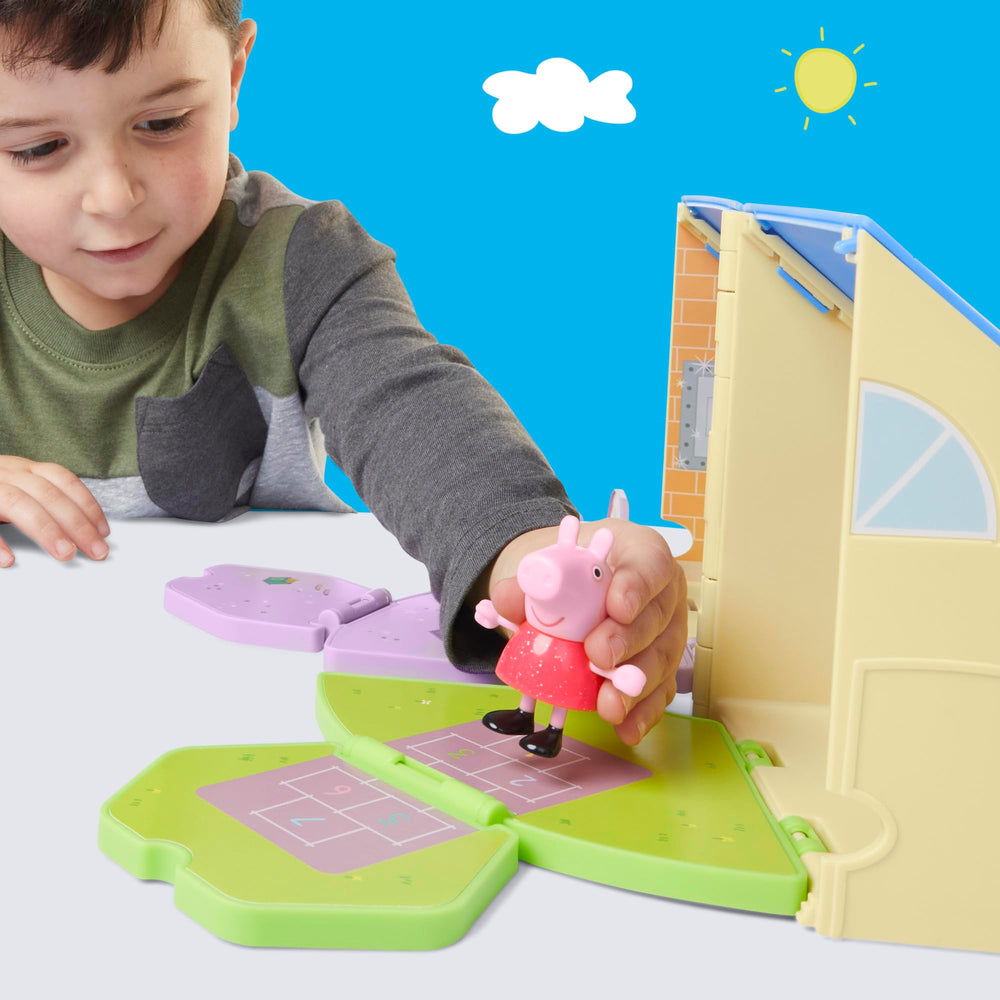 3-inch Peppa Pig figure wearing a red dress sits at playset furniture.