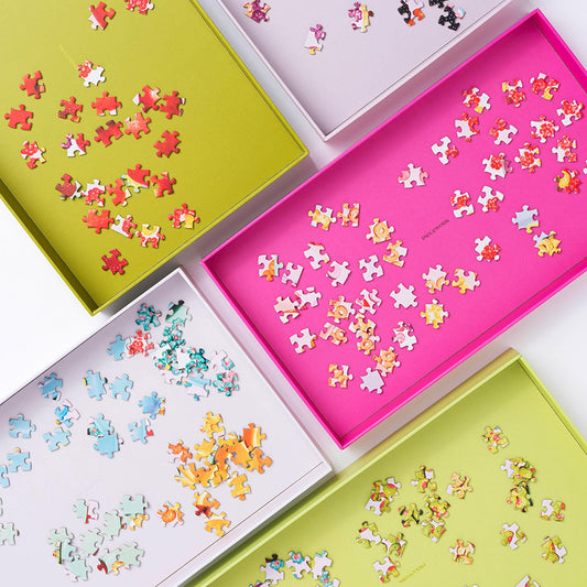 Piecework Puzzles stackable trays organize pieces by color and size