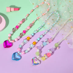 Close-up of PinkSheep heart pendant on kids' jewelry.