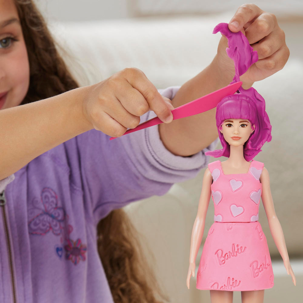 Barbie doll with movable arms for dynamic posing and dressing.